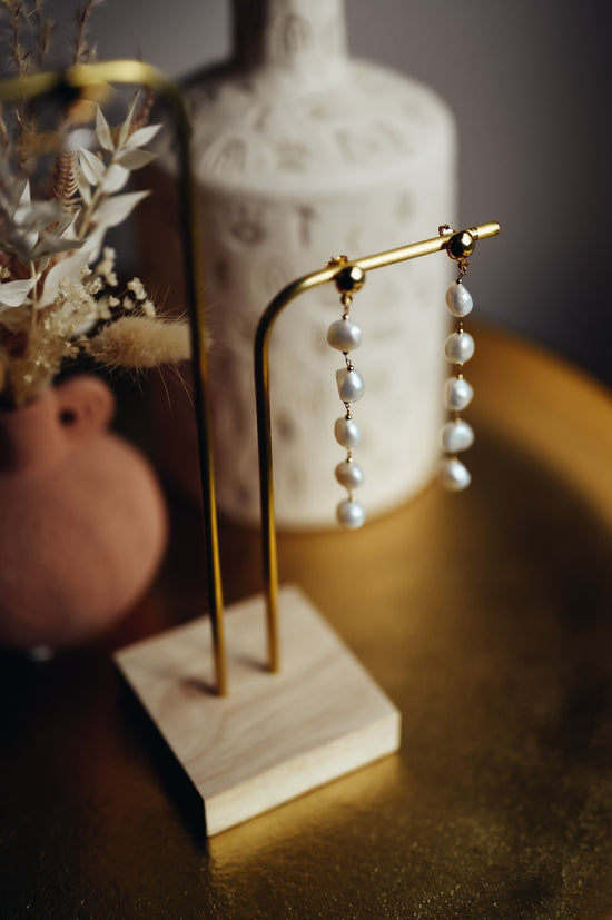 Boucles d'oreilles Émilie  Ces boucles d'oreilles délicates sont composées d'une succession de perles naturelles montées sur une chaîne plaqué-or 3 microns.   Ces boucles d’oreilles sont disponibles en clip pour les oreilles non-percées.